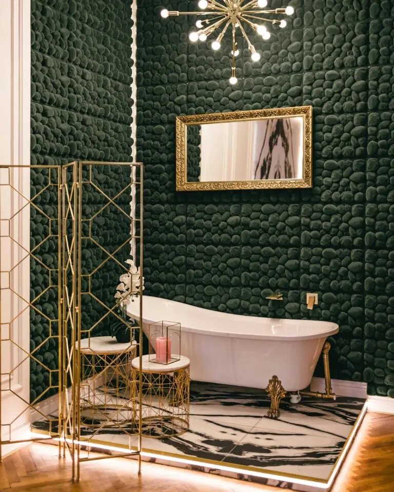 An elegant vintage bathroom featuring golden accents and a clawfoot bathtub in Prague.